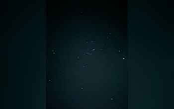 Milky Way glowing over a Komodo sailing boat at night during BOSE 4D3N tour in Indonesia.