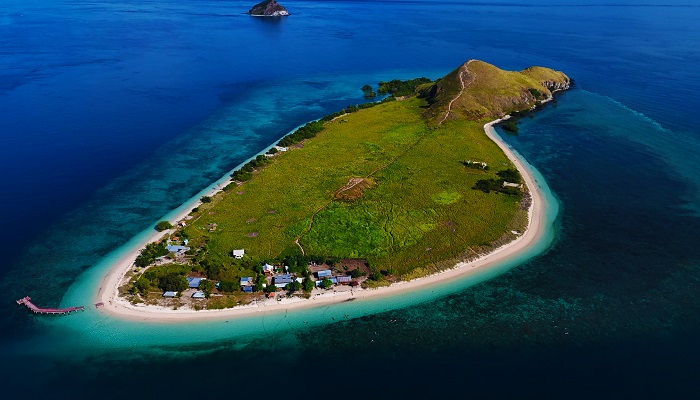 Aerial view of Kenawa Island’s green hills and white beach between Sumbawa and Lombok, a hidden stop on Komodo tour packages from Bali or Lombok.
