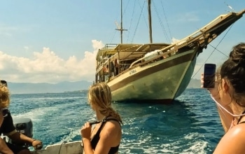Luxury phinisi boat preparing for departure at Labuan Bajo harbor for a 2026 Komodo tour.