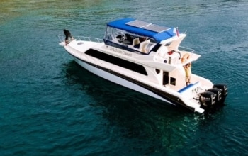 Speedboat racing through the blue waters of Komodo National Park. Efficient Komodo tour 1 day full trip from Labuan Bajo.