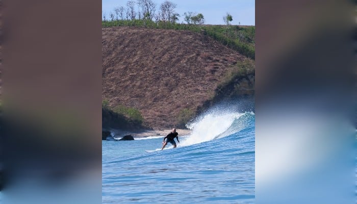 Luxury phinisi boat waiting for guests near Kuta Mandalika for a Komodo sailing trip Indonesia.